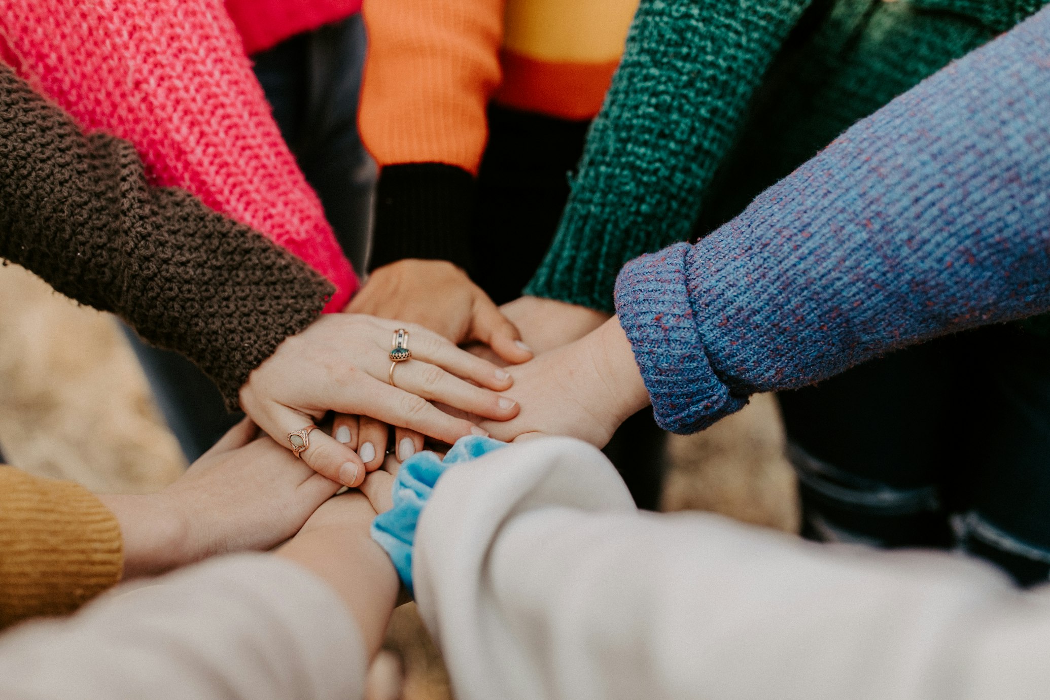 Team joining hands in a show of leadership and unity